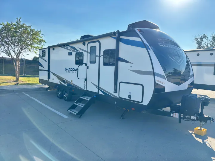 A Shadow Cruiser RV rental, parked outdoors on a sunny day, ready for adventure. Ideal for travel trailer enthusiasts.. Cruiser RV Shadow Cruiser 2021