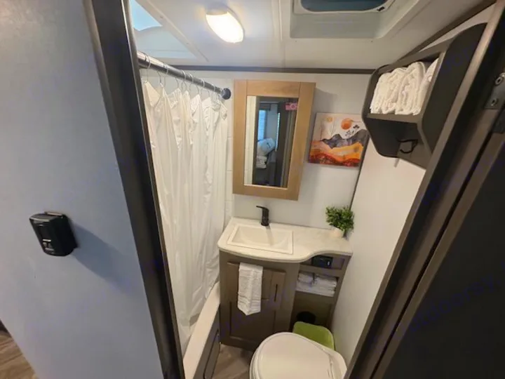 Clean, compact RV rental bathroom with a shower, vanity, toilet, and towel storage for comfortable travel.. Cruiser RV Shadow Cruiser 2021