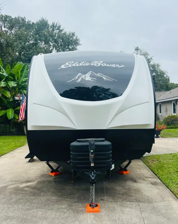 Eddie Bauer travel trailer, perfect for an rv rental, parked in a driveway. Ready for adventure and outdoor experiences!. Heartland RVs 265BH-L 2024