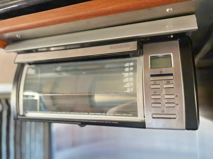 Compact Black+Decker Spacemaker toaster oven, under-cabinet mounted, ideal for an RV rental kitchen.. Roadtrek Roadtrek Class B 2017