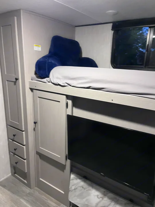 This **RV rental** features a well-appointed bunk bed, complete with soft bedding, a reading pillow, TV, and ample storage.. Coachmen Apex 300 BHS 2025