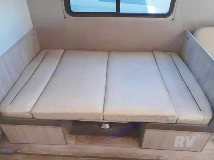 Flexible RV rental dinette converts to a bed, offering practical seating and sleeping options with under-seat storage.. Other Catalina 2025