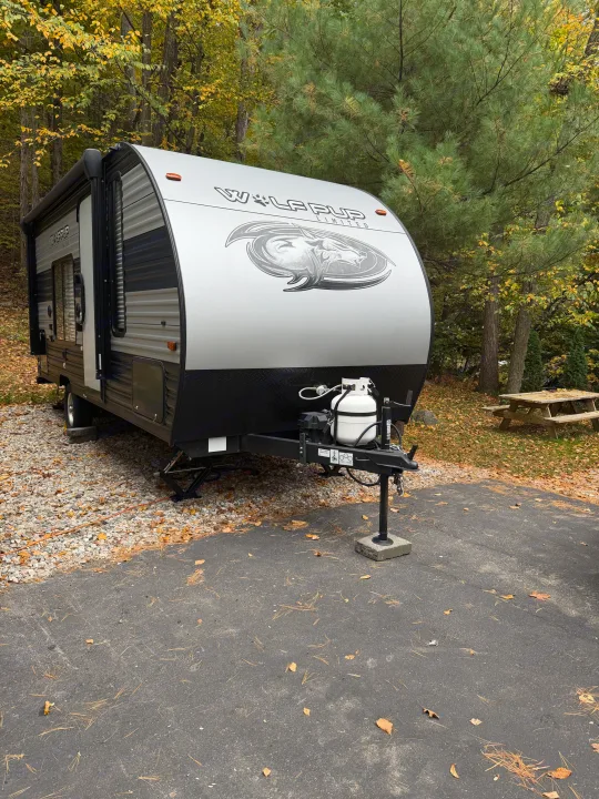 This rv rental, a "Wolf Pup" travel trailer, is ready for autumn camping adventures at a scenic campsite.. Forest River Cherokee Wolf Pup 2021