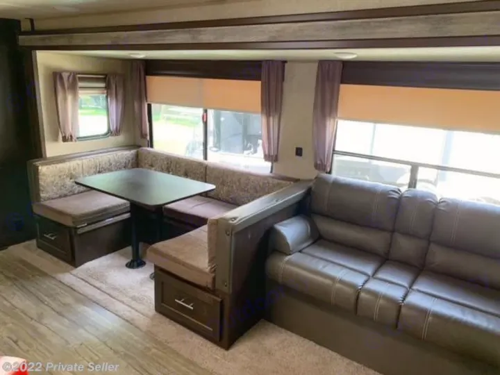 Spacious RV rental with a U-shaped dinette, comfortable sofa, and large windows for scenic views.. Forest River Cherokee 2018