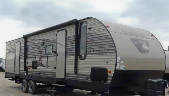 This tan and grey Cherokee Limited travel trailer, featuring a wolf graphic, is ready for your next rv rental adventure.. Forest River Cherokee 2018