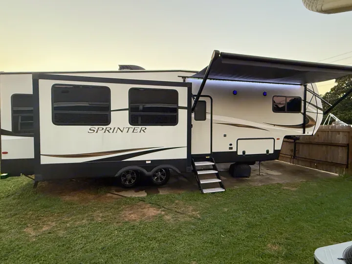 Spacious Sprinter RV rental with extended awning, blue lights, and slide-out. Ready for outdoor adventures!. Keystone RV Sprinter Campfire 2021
