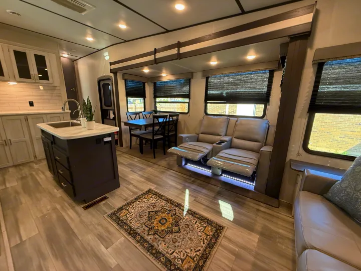 Experience comfort in this RV rental: modern kitchen, dining, and recliners on wood-look floors.. Keystone RV Sprinter Campfire 2021