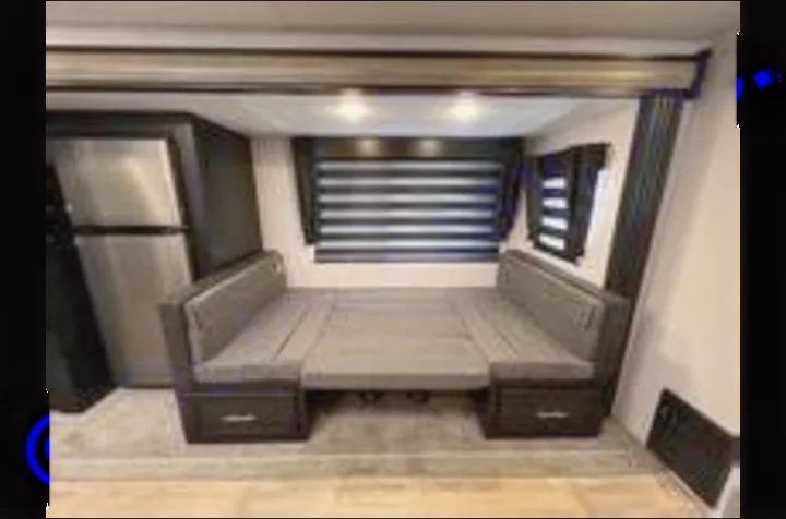 RV rental: This RV's dark-toned dinette converts to a bed, offering versatile seating and sleeping in a compact space.. Forest River Cherokee 2022