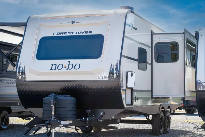 This beige/black Forest River NoBo travel trailer makes an ideal rv rental. Modern design, slide-out, and rugged tires for adventure.. Forest River No Boundaries 2026
