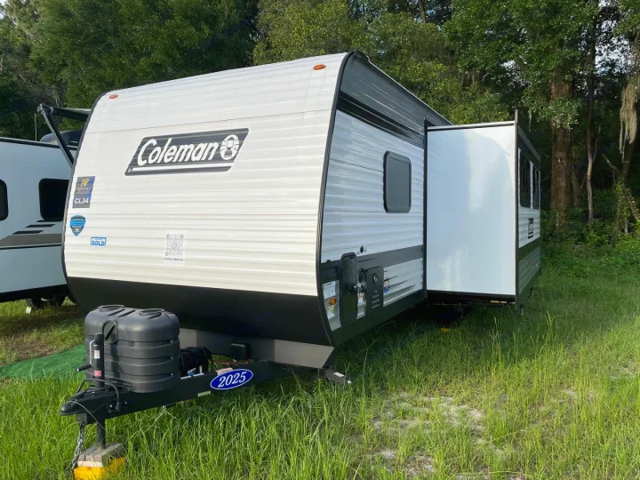 New Coleman travel trailer RV rental, model CL34, with a slide-out extended, ready for your next adventure.. COLEMAN 27B CM27B25 2025