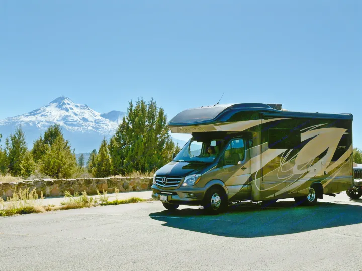 RV rental adventure! An Entegra Qwest motorhome rests at a scenic mountain overlook with a majestic snow-capped peak.. Entegra Coach Qwest 2019