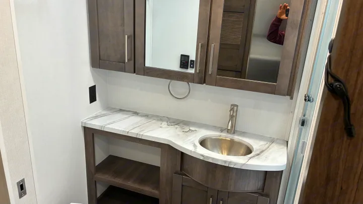 Modern RV rental bathroom vanity with sleek sink, marble-look countertop, and mirrored medicine cabinet.. Jayce Precept G 2026