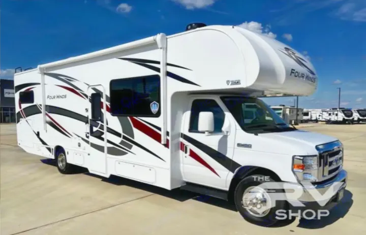 White Thor Four Winds Class C RV for rent, featuring bold graphics. Ideal motorhome for your next adventure.. Thor Four Winds 2023