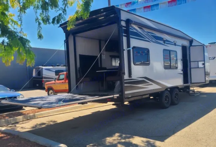 Check out this rv rental: a modern toy hauler with its rear ramp creating an inviting outdoor patio space.. Genesis Supreme Rv Genesis Supreme 2022