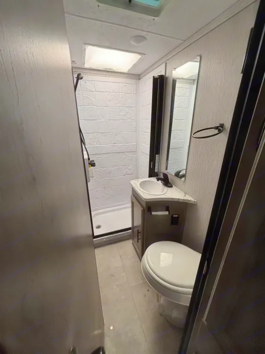 This RV rental offers a well-equipped bathroom, including a shower with skylight, sink, and toilet for convenience.. Forest River Coachmen Cross Trek 2021