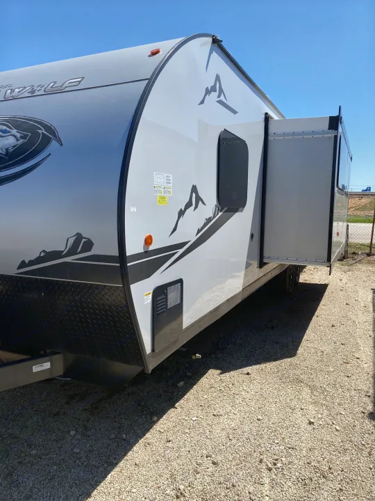 Grey Wolf RV rental with slide-out extended, parked on gravel. Ready for your next adventure!. Forest River Cherokee Grey Wolf 2022