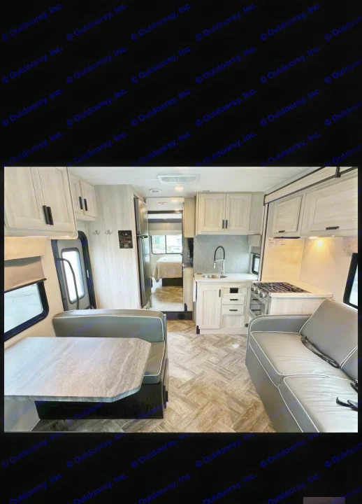 Spacious, modern RV rental interior with dining, kitchen, and living areas, plus a glimpse of the bedroom. Ready for travel!. Forester LE 2023