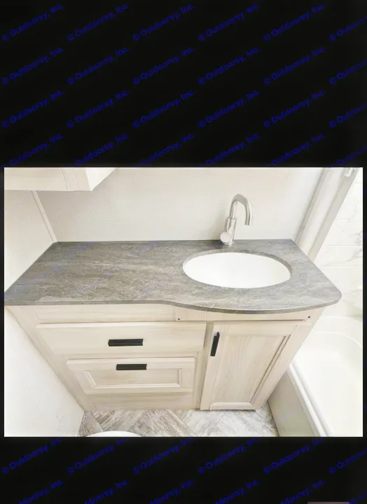 This rv rental boasts a functional bathroom vanity with a dark countertop, oval sink, and modern faucet.. Forester LE 2023