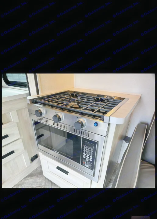 Compact RV rental kitchen features stainless steel stovetop, oven, & microwave built into light wood cabinetry.. Forester LE 2023