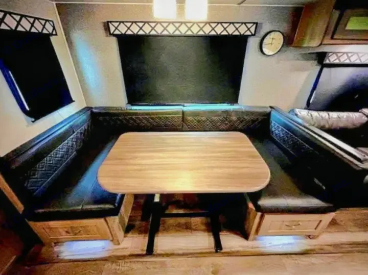 Enjoy this RV rental's U-shaped dinette: comfortable seating, a wooden table, and convenient under-seat storage.. Coachmen Other 2020