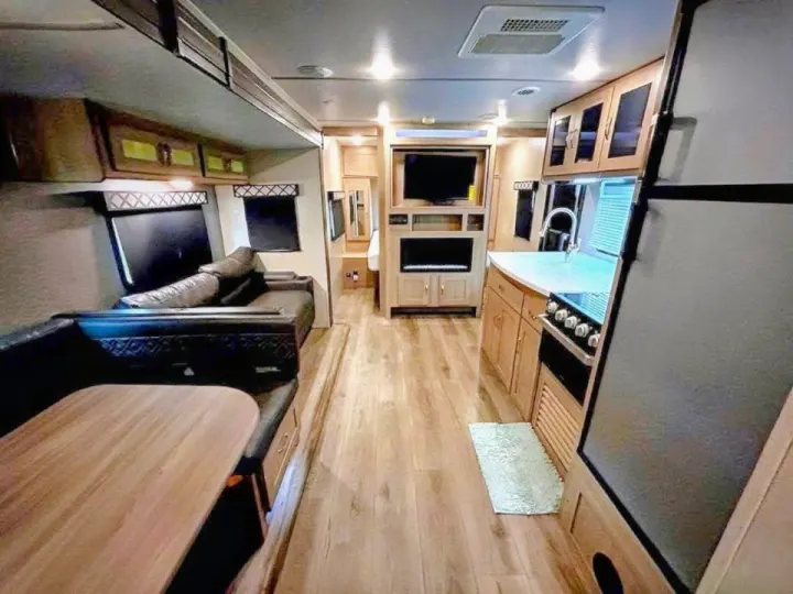 Experience a spacious, modern RV rental interior. Features a well-equipped kitchen, comfy dinette, and sofa living area.. Coachmen Other 2020