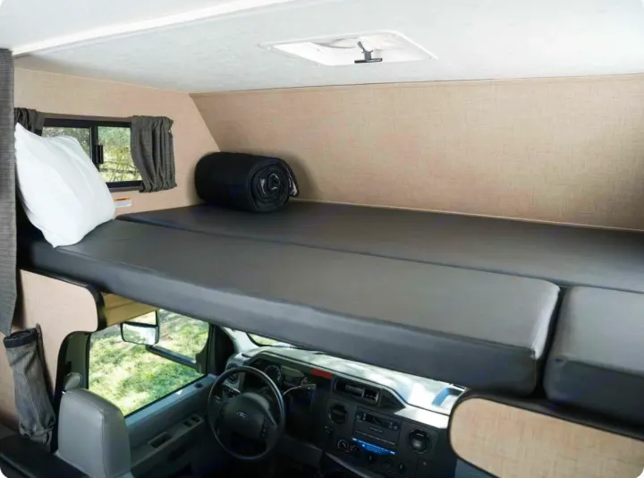 RV rental: Cozy over-cab bunk bed and front cabin area visible, perfect for road trip adventures.. Thor Majestic 2019