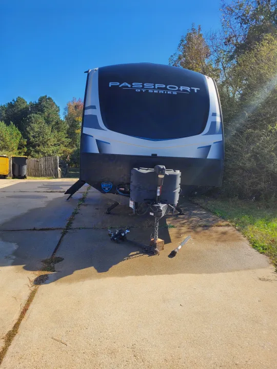 This Passport GT Series travel trailer is ready for your RV rental. Parked on concrete with a clear sky.. Keystone RV Passport GT 2022