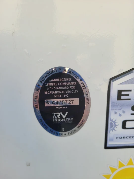 RVIA safety certification sticker with serial S A475727 on an rv rental, confirming electrical, plumbing, heating, and fire safety.. Keystone RV Passport GT 2022