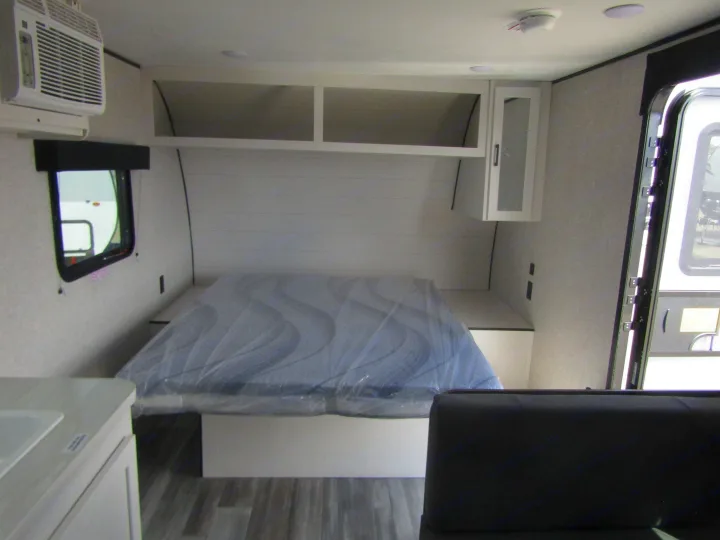 RV rental interior featuring a compact bedroom with a bed, air conditioner, and overhead storage.. Jayco Jay Flight SLX 2025
