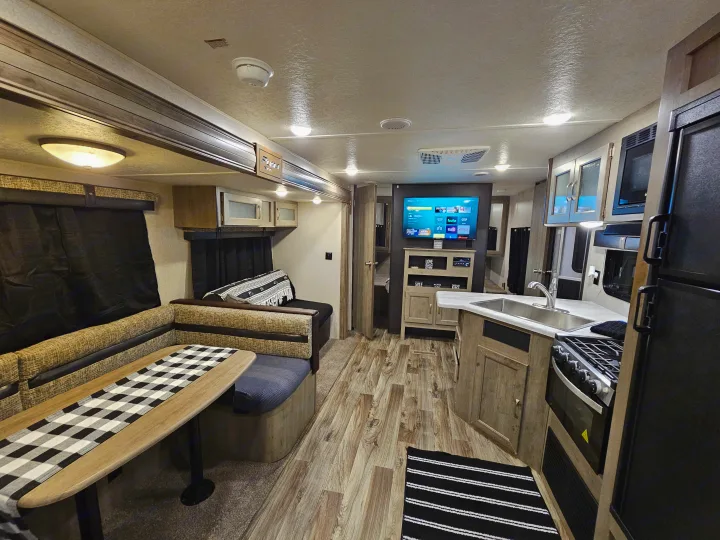 Spacious RV rental interior featuring a modern kitchen, cozy dinette, and entertainment setup for your travels.. Forest River Palomino Puma XLE 2019