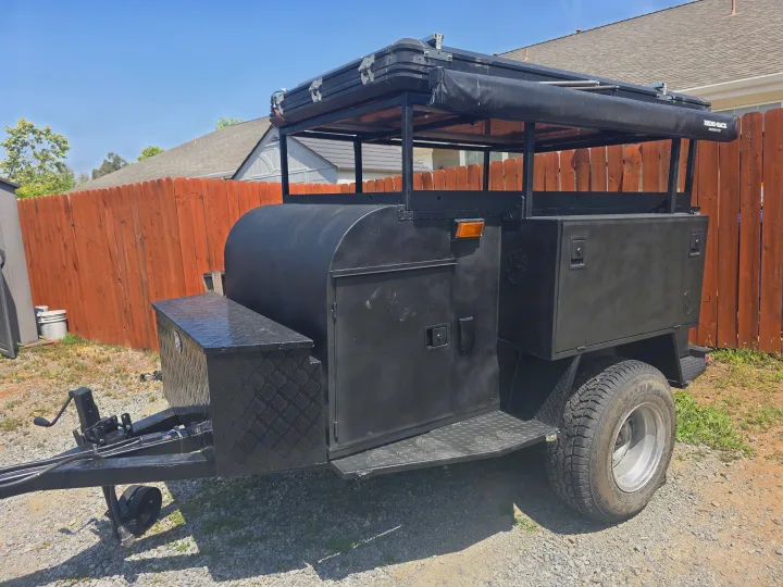 Explore with this robust black off-road camper trailer, featuring a rooftop tent and awning, ideal for rv rental.. Custom Build Offroad Trailer 2021