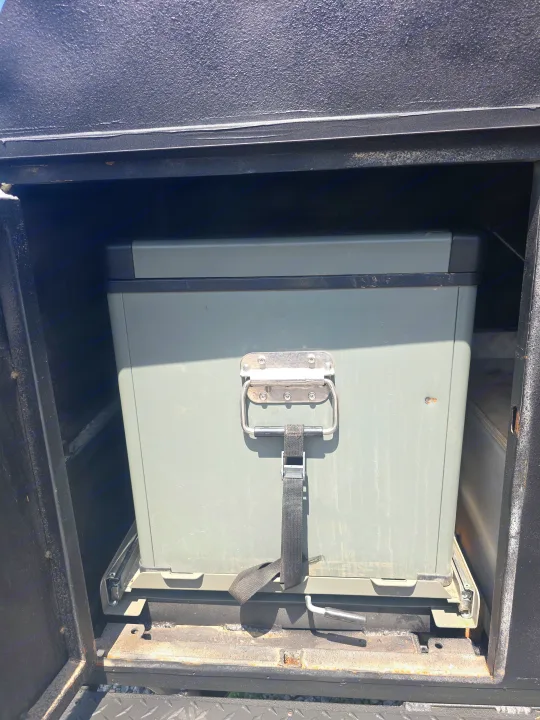 RV rental ready: A heavy-duty gray storage box on a pull-out slide system within a vehicle compartment, ideal for gear.. Custom Build Offroad Trailer 2021