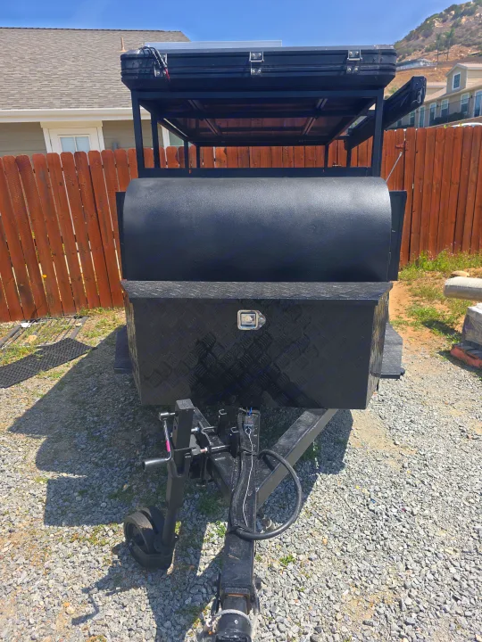 Front view of a rugged black utility trailer with a rooftop tent and storage, perfect for an rv rental adventure.. Custom Build Offroad Trailer 2021