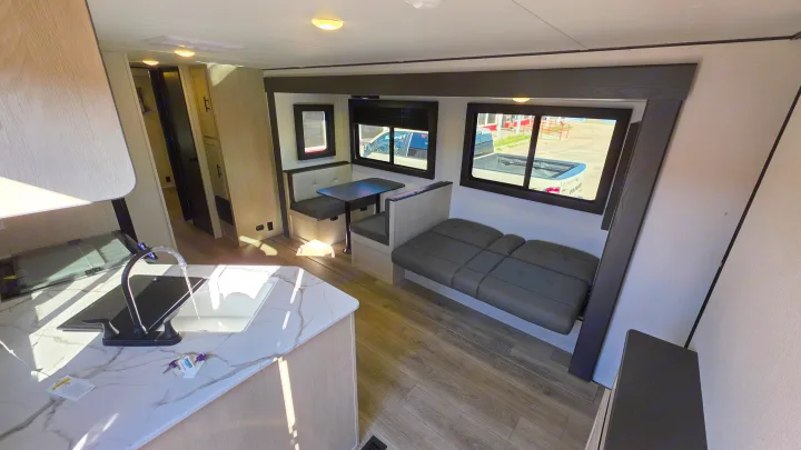 Explore this modern rv rental's interior: a kitchen, dinette, and side lounge with large windows for outdoor views.. Forest River Shasta I-5 2025