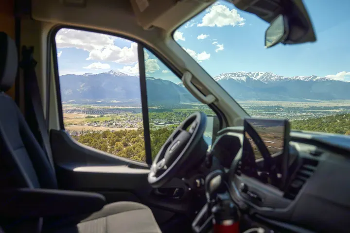 Enjoy breathtaking mountain views from your RV rental. This spacious van offers scenic travel and adventure with incredible vistas.. Ford Transit 2023