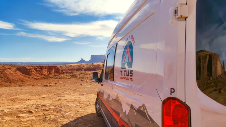 Titus Adventure Co. RV rental in a breathtaking desert canyon. Perfect for van life & exploring iconic red rock landscapes.. Ford Transit 2023