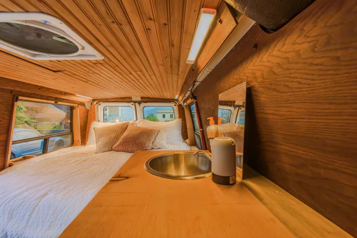 This RV rental features a cozy interior: comfy bed, compact sink, and beautiful wood paneling. Ready for your adventure.. Ford Econoline E250supercab 2008
