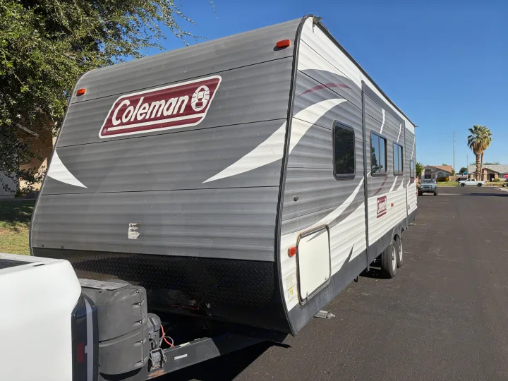 Coleman RV rental: A grey and white travel trailer is parked outside on a sunny day, ready for camping adventures.. Dutchmen Coleman Lantern 2018