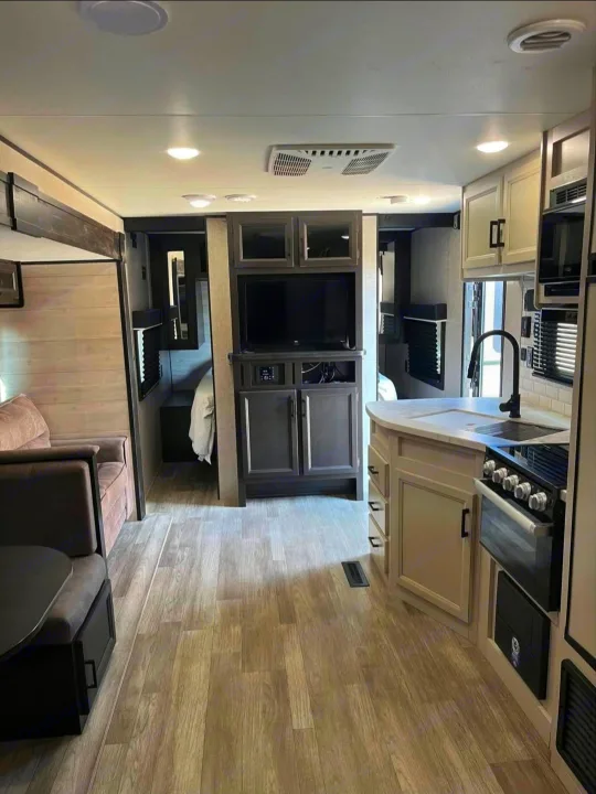 Inside this inviting RV rental: a full kitchen, comfy living space with dinette, and private bedroom area.. Jayco Jay Flight Baja Edition 2023