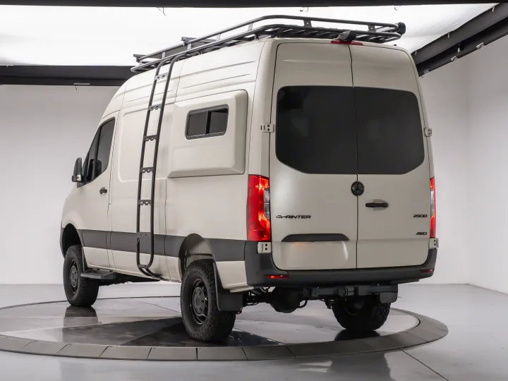 This adventure-ready Mercedes Sprinter 4x4 camper van, ideal for your next rv rental, features a roof rack & ladder.. MERCEDES-BENZ Sprinter 2500 AWD 2024