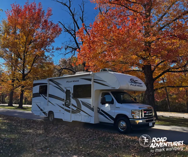 Scenic RV rental parked under brilliant fall trees. Ideal for a road adventure to soak in autumn's beauty.. Thor Motor Coach Four Winds 28Z 2024