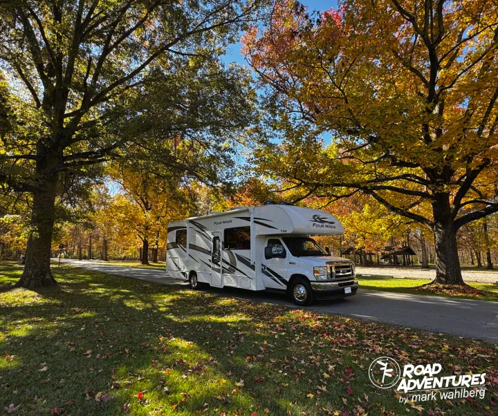 Explore nature's beauty in an RV rental! This Four Winds RV is parked amid vibrant fall foliage, perfect for road adventures.. Thor Motor Coach Four Winds 28Z 2024