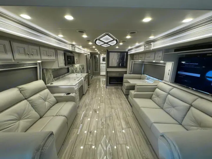 Experience luxury rv rental in this spacious, modern motorhome, featuring dual sofas, full kitchen, dining nook, fireplace, and TV.. Holiday Rambler Armada 2022
