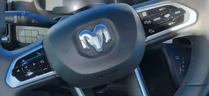 Ram RV rental steering wheel: features logo and integrated driver controls for lights, cruise, and phone management.. Winnebago Solis 2025