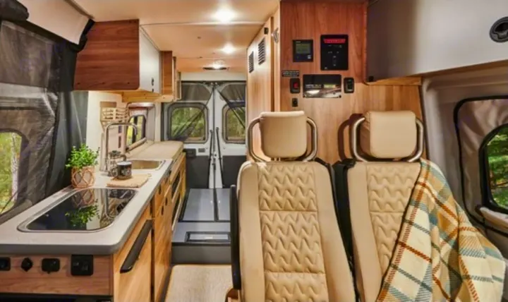 Modern **RV rental** interior with full kitchen, swivel seats, and smart controls, ready for adventure.. Winnebago Solis 2025