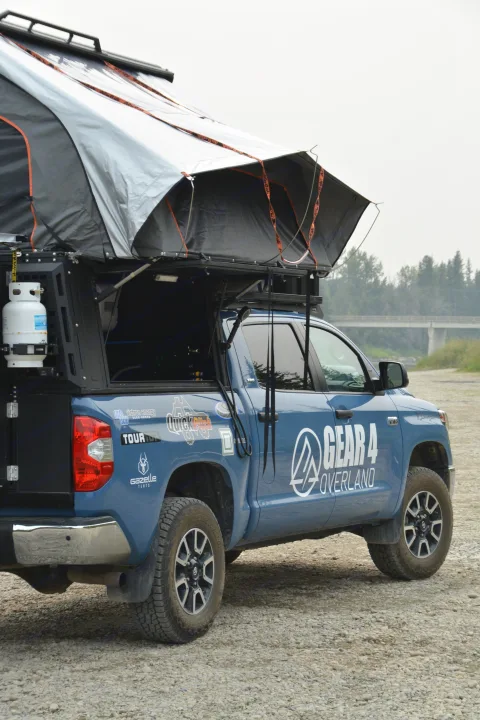 Blue overlanding pickup truck with a rooftop tent, ideal for your next RV rental adventure or outdoor camping trip.. Toyota Tundra 2021