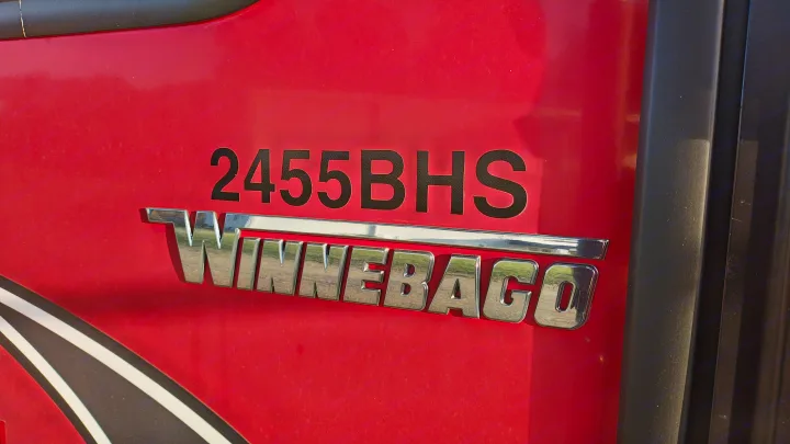 Winnebago 2455BHS RV rental: Close-up of the red exterior with chrome badging and model number.. Minnie Minnie Trailer 2019