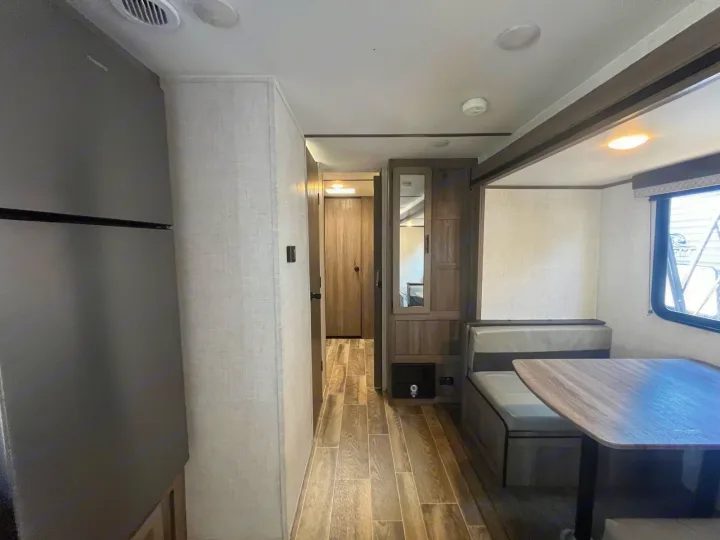 Step into this modern rv rental's interior: spacious, with a dinette, kitchen appliance, and hallway to a rear room.. Gulf Stream Kingsport 2023