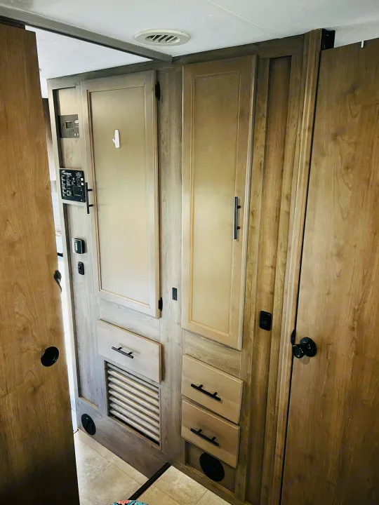 RV rental interior wall with light wood cabinetry, a control panel, and various vents and hardware.. Forest River Coachmen Freelander Premier 2021