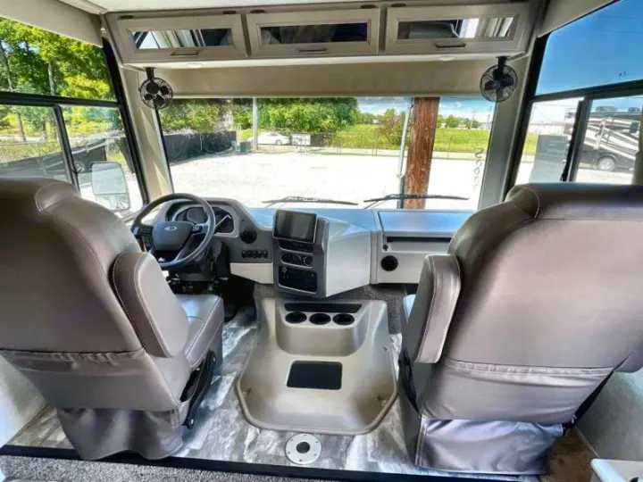 RV rental: The spacious front cockpit features comfortable driver and passenger seats, a modern dashboard, and panoramic views.. Thor Windsport 2023
